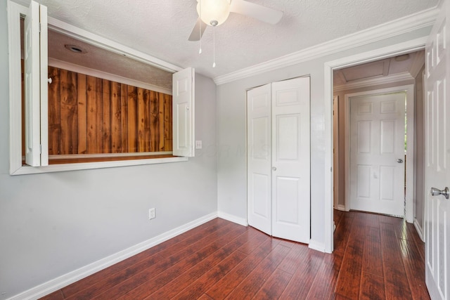 3840 Farm Brook Ln, Columbus, OH 43204 - unfurnished bedroom featuring dark wood-style flooring, ornamental molding, a textured ceiling, a closet, and ceiling fan