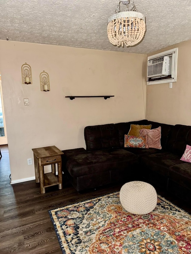 375 Darby Ct, Galloway, OH 43119 - living room with wood finished floors, a textured ceiling, a chandelier, and a wall mounted air conditioner