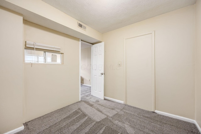 1530 Slade Ave Unit 101, Columbus, OH 43235 - unfurnished bedroom featuring carpet flooring, a textured ceiling, and baseboards