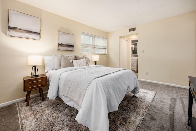 1530 Slade Ave Unit 101, Columbus, OH 43235 - carpeted bedroom featuring baseboards and ensuite bath