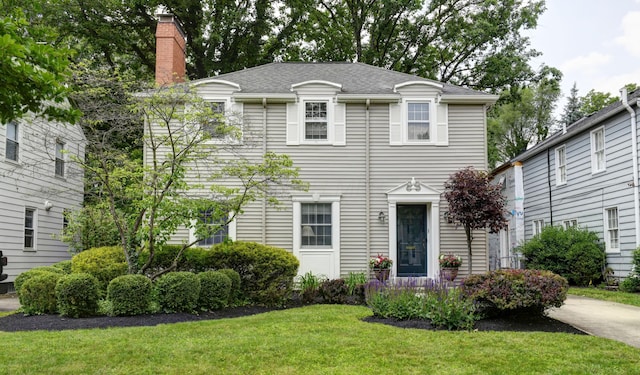 259 N Stanwood Rd, Columbus, OH 43209 - view of front of home featuring a front lawn, a chimney, and a shingled roof