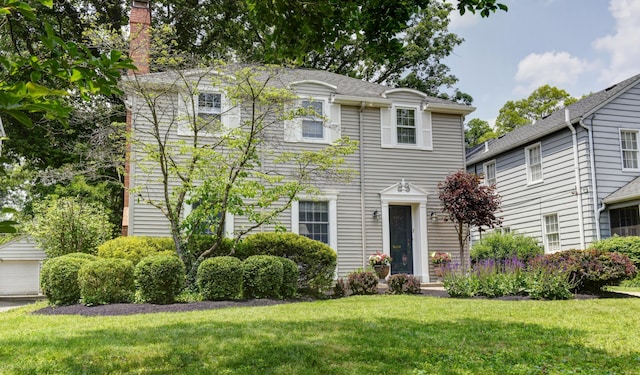 259 N Stanwood Rd, Columbus, OH 43209 - view of front of property featuring a front lawn, a chimney, and a garage
