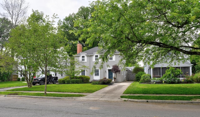 259 N Stanwood Rd, Columbus, OH 43209 - colonial inspired home with a chimney, a front lawn, and driveway