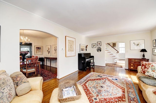 259 N Stanwood Rd, Columbus, OH 43209 - living room featuring arched walkways, wood finished floors, crown molding, stairway, and a chandelier