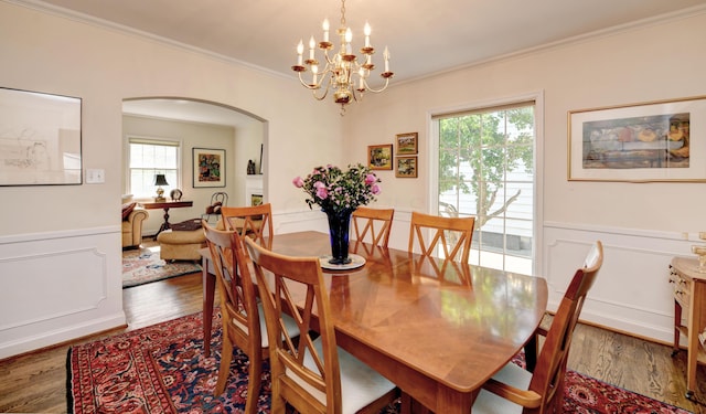 259 N Stanwood Rd, Columbus, OH 43209 - dining room with arched walkways, crown molding, wood finished floors, healthy amount of natural light, and a wainscoted wall