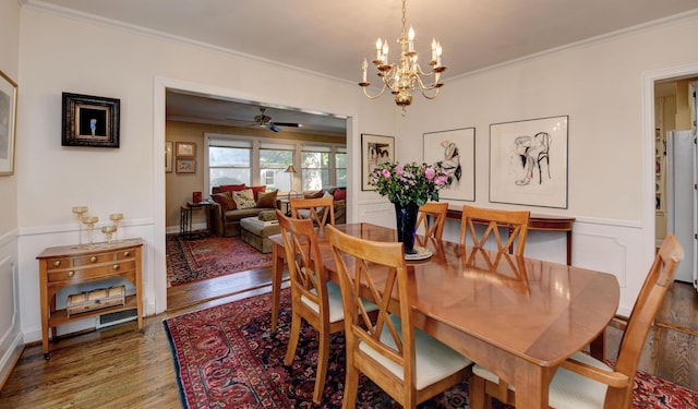 259 N Stanwood Rd, Columbus, OH 43209 - dining area featuring crown molding, wood finished floors, a chandelier, ceiling fan, and a decorative wall