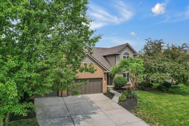 4583 Hunting Creek Dr, Grove City, OH 43123 - view of front of property with brick siding, a front lawn, driveway, an attached garage, and a shingled roof