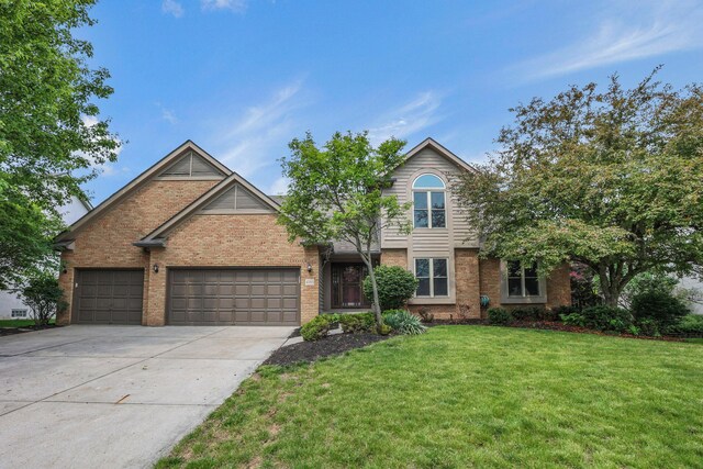 4583 Hunting Creek Dr, Grove City, OH 43123 - traditional home with brick siding, concrete driveway, an attached garage, and a front lawn