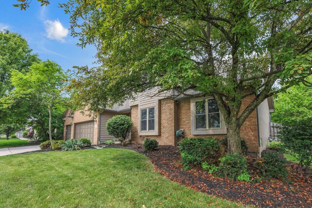 4583 Hunting Creek Dr, Grove City, OH 43123 - obstructed view of property with a front lawn, brick siding, and an attached garage