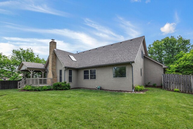 4583 Hunting Creek Dr, Grove City, OH 43123 - back of house featuring stucco siding, a shingled roof, and a chimney