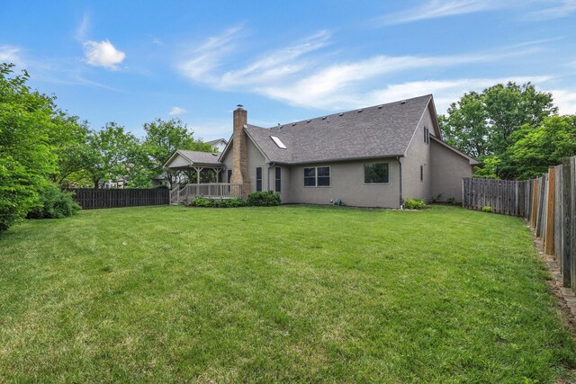 4583 Hunting Creek Dr, Grove City, OH 43123 - rear view of house with stucco siding, a chimney, and a shingled roof