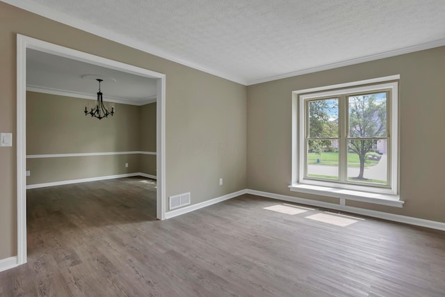 4583 Hunting Creek Dr, Grove City, OH 43123 - spare room featuring a chandelier, wood finished floors, a textured ceiling, crown molding, and baseboards