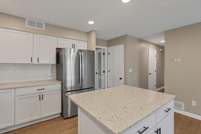 4583 Hunting Creek Dr, Grove City, OH 43123 - kitchen featuring freestanding refrigerator, light wood finished floors, white cabinetry, and recessed lighting