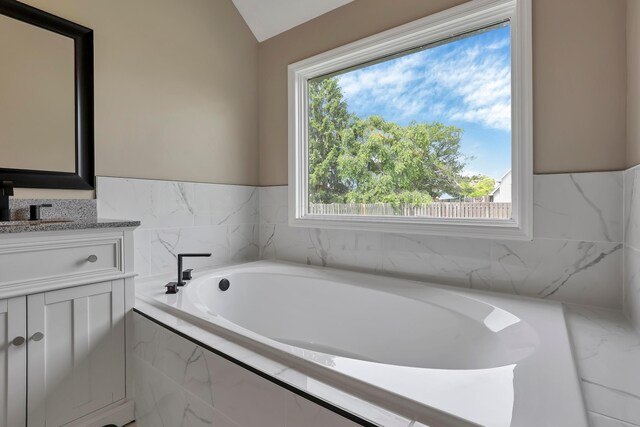 4583 Hunting Creek Dr, Grove City, OH 43123 - full bathroom featuring vanity, a bath, and lofted ceiling