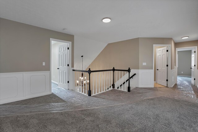 4583 Hunting Creek Dr, Grove City, OH 43123 - hallway featuring an upstairs landing, carpet flooring, a wainscoted wall, and a chandelier