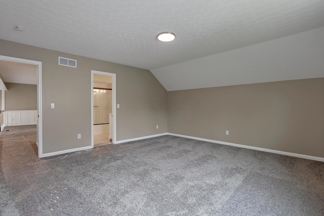 4583 Hunting Creek Dr, Grove City, OH 43123 - bonus room with carpet flooring, baseboards, vaulted ceiling, and a textured ceiling