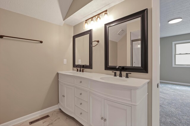 4583 Hunting Creek Dr, Grove City, OH 43123 - full bath featuring a textured ceiling, double vanity, baseboards, and marble finish flooring