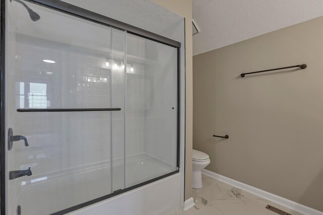 4583 Hunting Creek Dr, Grove City, OH 43123 - bathroom featuring toilet, enclosed tub / shower combo, marble finish flooring, and baseboards