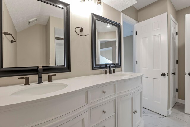 4583 Hunting Creek Dr, Grove City, OH 43123 - full bath with marble look tiles, double vanity, and a textured ceiling