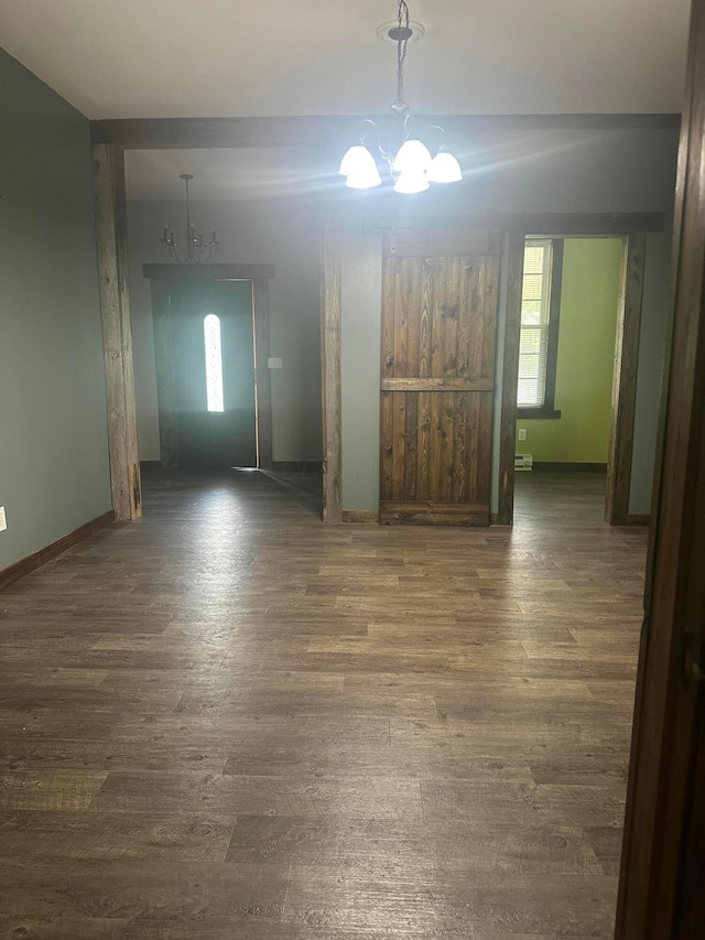 287 W Columbus St, Mount Sterling, OH 43143 - unfurnished dining area featuring a chandelier, wood finished floors, and baseboards