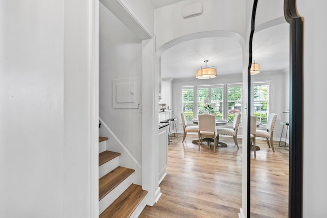 1572 Barrington Rd, Upper Arlington, OH 43221 - entrance foyer with arched walkways, light wood-style flooring, stairway, and baseboards
