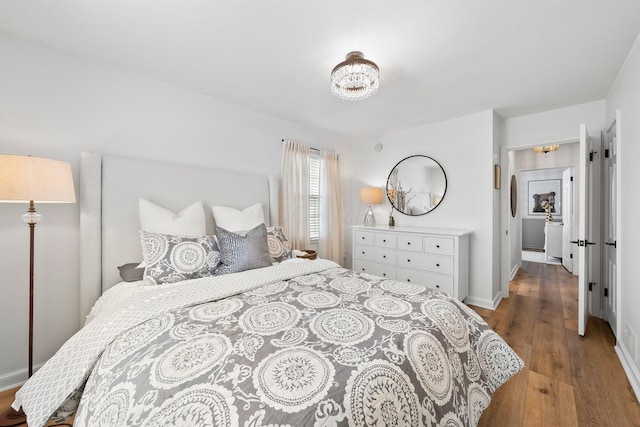 1572 Barrington Rd, Upper Arlington, OH 43221 - bedroom with wood finished floors, a chandelier, and baseboards