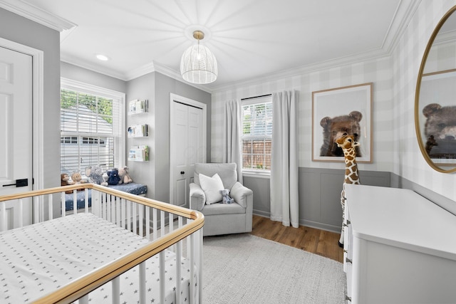 1572 Barrington Rd, Upper Arlington, OH 43221 - bedroom featuring wood finished floors, ornamental molding, multiple windows, wainscoting, and a closet