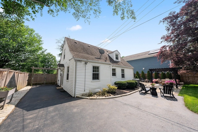 1572 Barrington Rd, Upper Arlington, OH 43221 - back of property with a pergola, a patio area, and a shingled roof