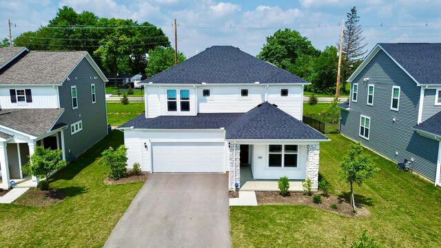 3895 Brody Dr, Grove City, OH 43123 - view of front facade with driveway, an attached garage, roof with shingles, a front lawn, and stone siding