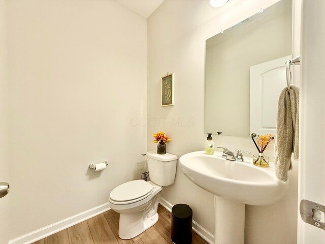 3895 Brody Dr, Grove City, OH 43123 - half bath featuring baseboards, wood finished floors, and toilet