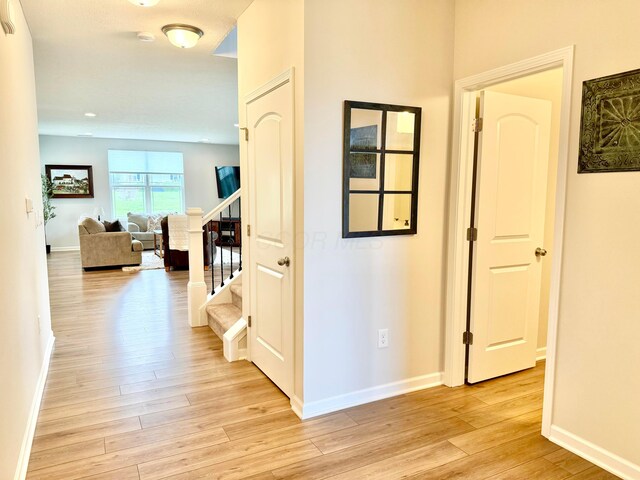 3895 Brody Dr, Grove City, OH 43123 - corridor featuring light wood-style flooring, baseboards, and stairs