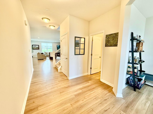 3895 Brody Dr, Grove City, OH 43123 - hallway with light wood-style flooring, stairs, and baseboards