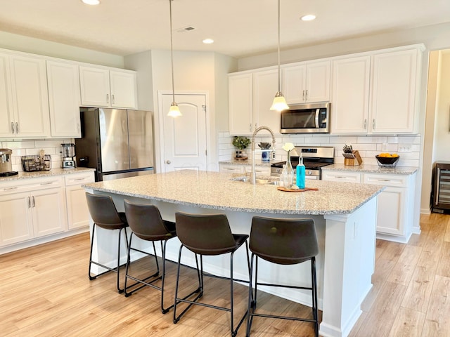 3895 Brody Dr, Grove City, OH 43123 - kitchen with stainless steel appliances, tasteful backsplash, white cabinets, and recessed lighting