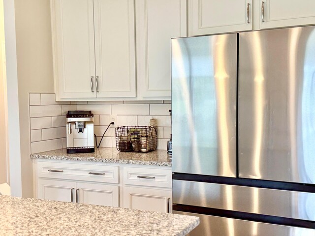3895 Brody Dr, Grove City, OH 43123 - kitchen featuring freestanding refrigerator, tasteful backsplash, white cabinetry, and light stone countertops