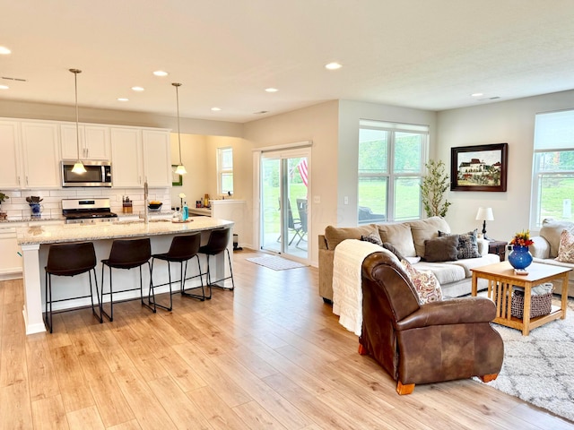 3895 Brody Dr, Grove City, OH 43123 - living area featuring light wood finished floors, plenty of natural light, and recessed lighting