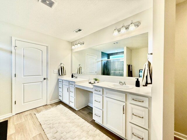 3895 Brody Dr, Grove City, OH 43123 - full bath featuring two vanities, a stall shower, wood finished floors, and a textured ceiling