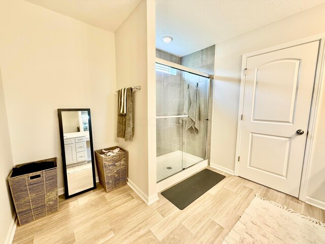 3895 Brody Dr, Grove City, OH 43123 - full bath featuring wood finished floors, a stall shower, and baseboards