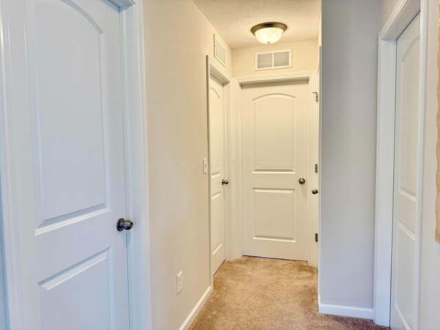 3895 Brody Dr, Grove City, OH 43123 - hall with light colored carpet, a textured ceiling, and baseboards
