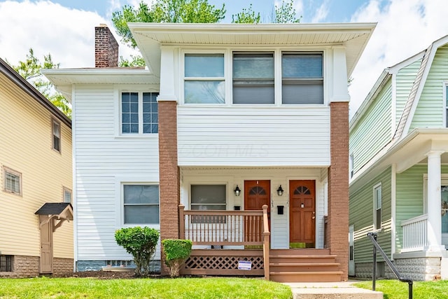 1121 Oakwood Ave, Columbus, OH 43206 - view of front facade with a porch and a chimney