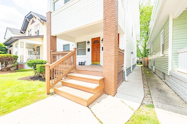 1121 Oakwood Ave, Columbus, OH 43206 - view of exterior entry with a porch and a yard