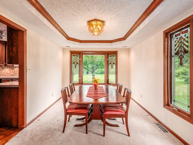 5434 Flat Head Ct, Columbus, OH 43230 - dining room featuring a tray ceiling, a textured ceiling, ornamental molding, a chandelier, and baseboards
