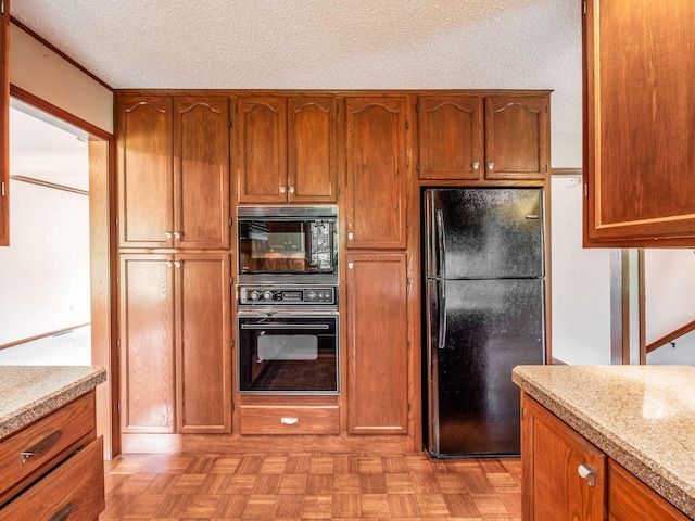 5434 Flat Head Ct, Columbus, OH 43230 - kitchen featuring black appliances, brown cabinetry, and a textured ceiling