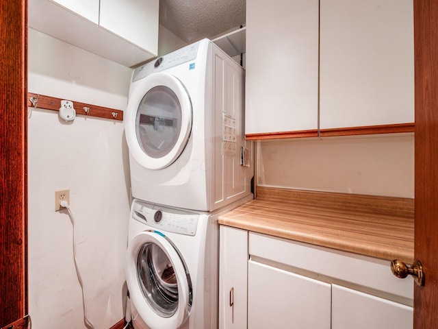 5434 Flat Head Ct, Columbus, OH 43230 - laundry area featuring stacked washer / dryer and cabinet space