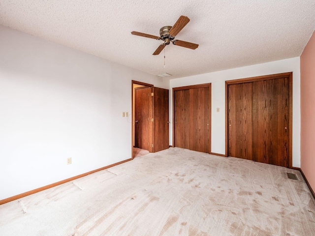 5434 Flat Head Ct, Columbus, OH 43230 - unfurnished bedroom with multiple closets, carpet flooring, baseboards, and a textured ceiling