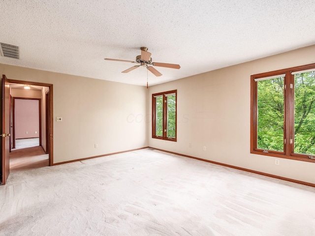 5434 Flat Head Ct, Columbus, OH 43230 - spare room with baseboards, light carpet, a ceiling fan, and a textured ceiling