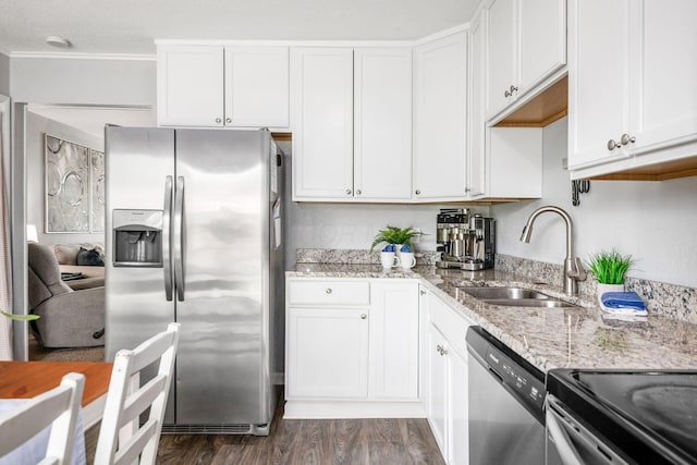 1058 Erickson Ave, Columbus, OH 43227 - kitchen featuring appliances with stainless steel finishes, a sink, white cabinets, light stone countertops, and dark wood-style flooring