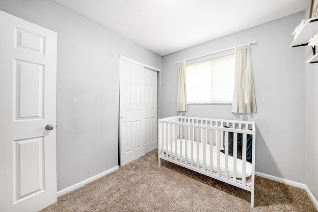 1058 Erickson Ave, Columbus, OH 43227 - carpeted bedroom featuring a closet, baseboards, and a nursery area