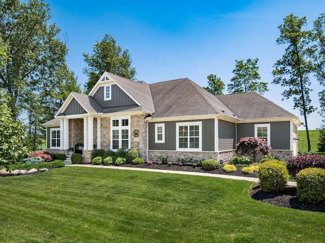 2235 Forestview Ln, Delaware, OH 43015 - craftsman inspired home with stone siding, board and batten siding, a front lawn, and a shingled roof