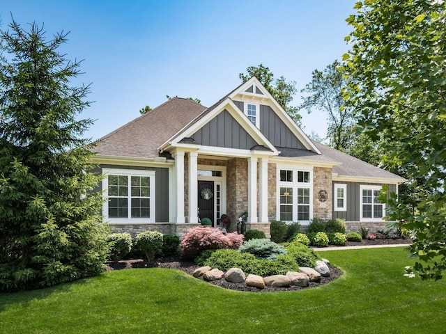 2235 Forestview Ln, Delaware, OH 43015 - craftsman house featuring board and batten siding, stone siding, a front yard, and a shingled roof