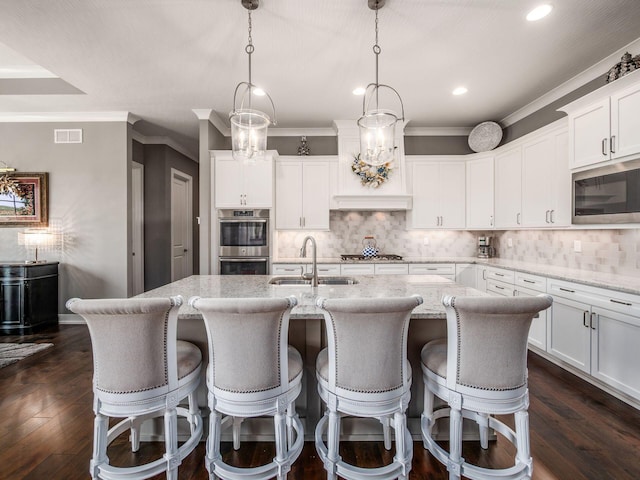 2235 Forestview Ln, Delaware, OH 43015 - kitchen with stainless steel appliances, recessed lighting, a center island with sink, decorative backsplash, and white cabinets